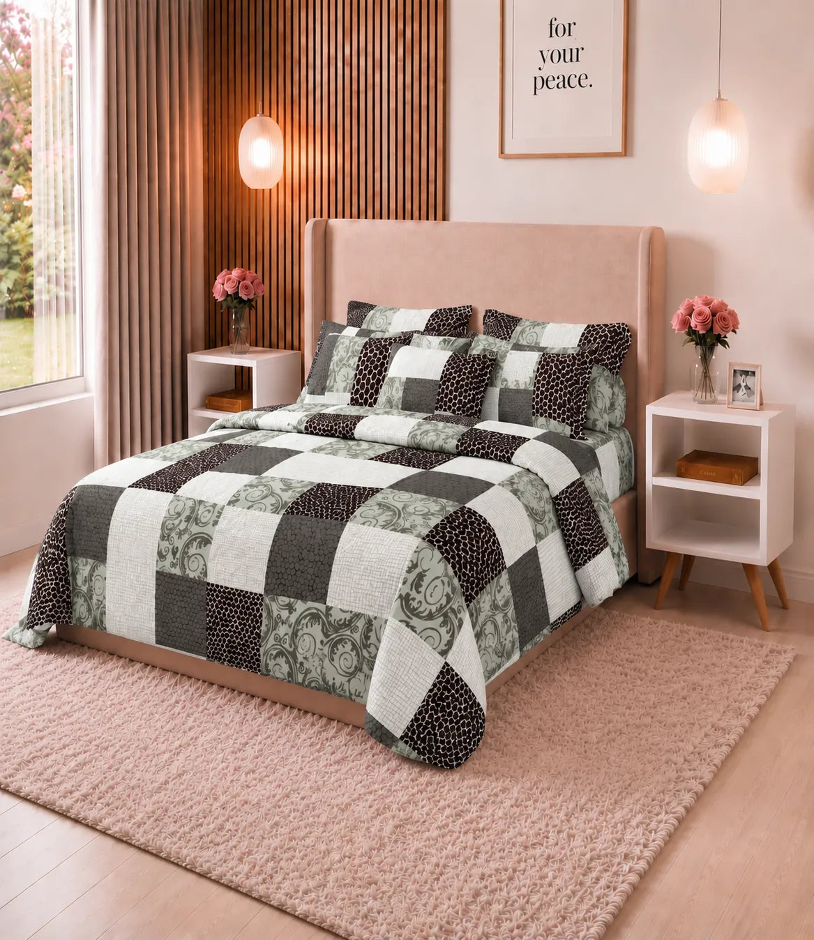 Angled view of a queen size cotton bedsheet featuring a geometric patchwork print in black, grey, sage green, and white, paired with coordinated pillow covers in a stylish bedroom setting.
