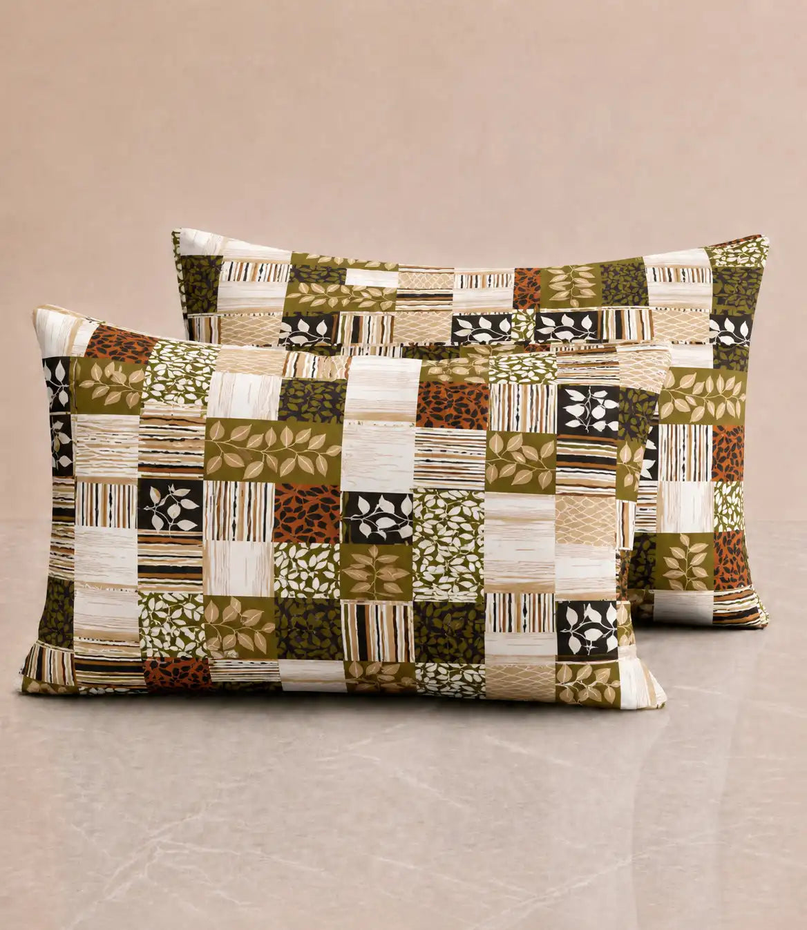 Matching 100% cotton pillow covers with earthy patchwork print in olive green, beige, cream, black, and rust for a contemporary bedroom décor.