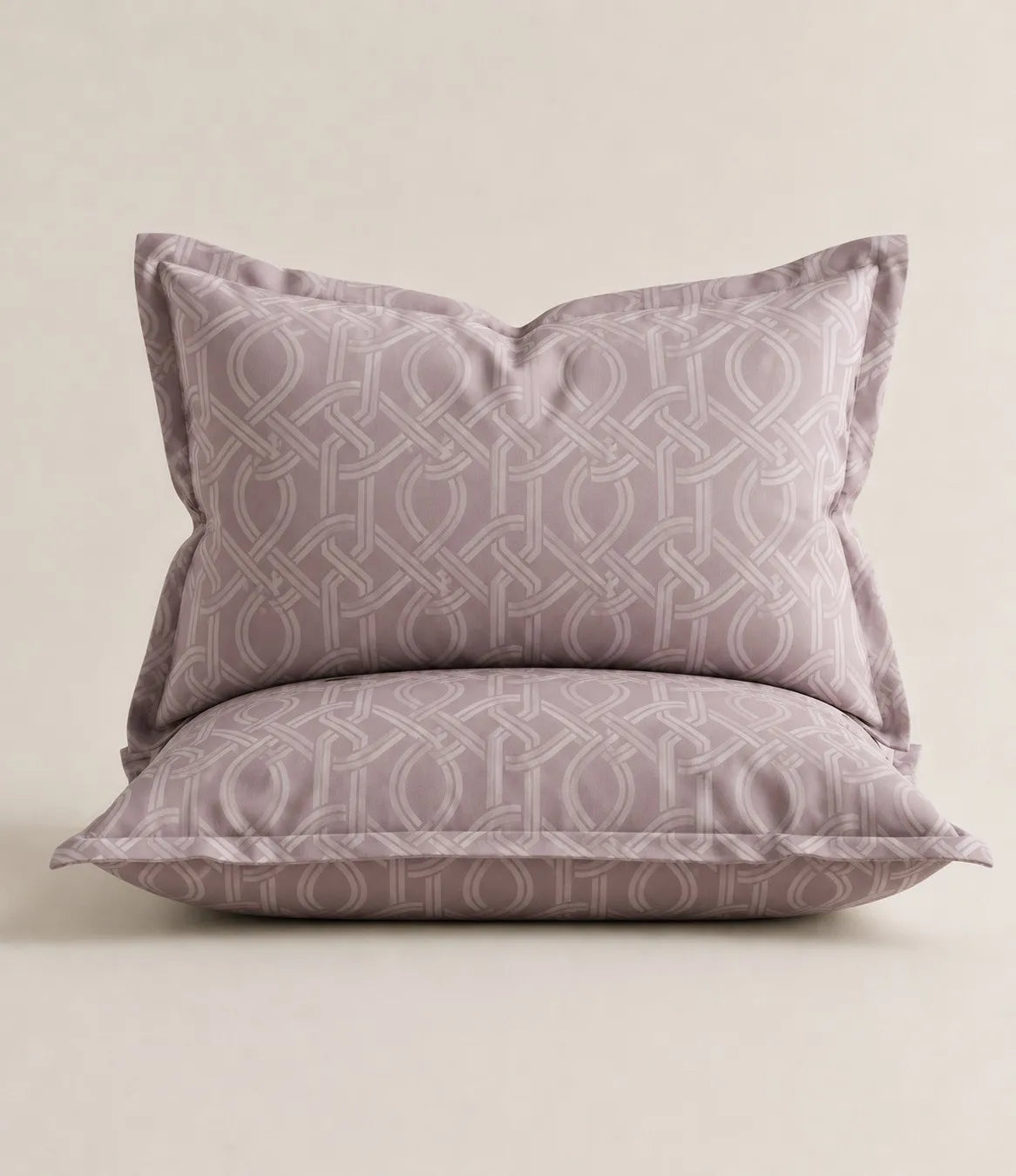 Blush mauve cotton pillow covers with interwoven geometric pattern, matching king size bedsheet set.