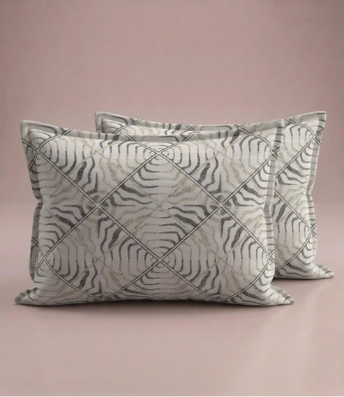 Matching 100% pure cotton pillow covers with an elegant abstract wave geometric pattern in ivory, taupe, sage green, and charcoal for a modern bedroom décor.