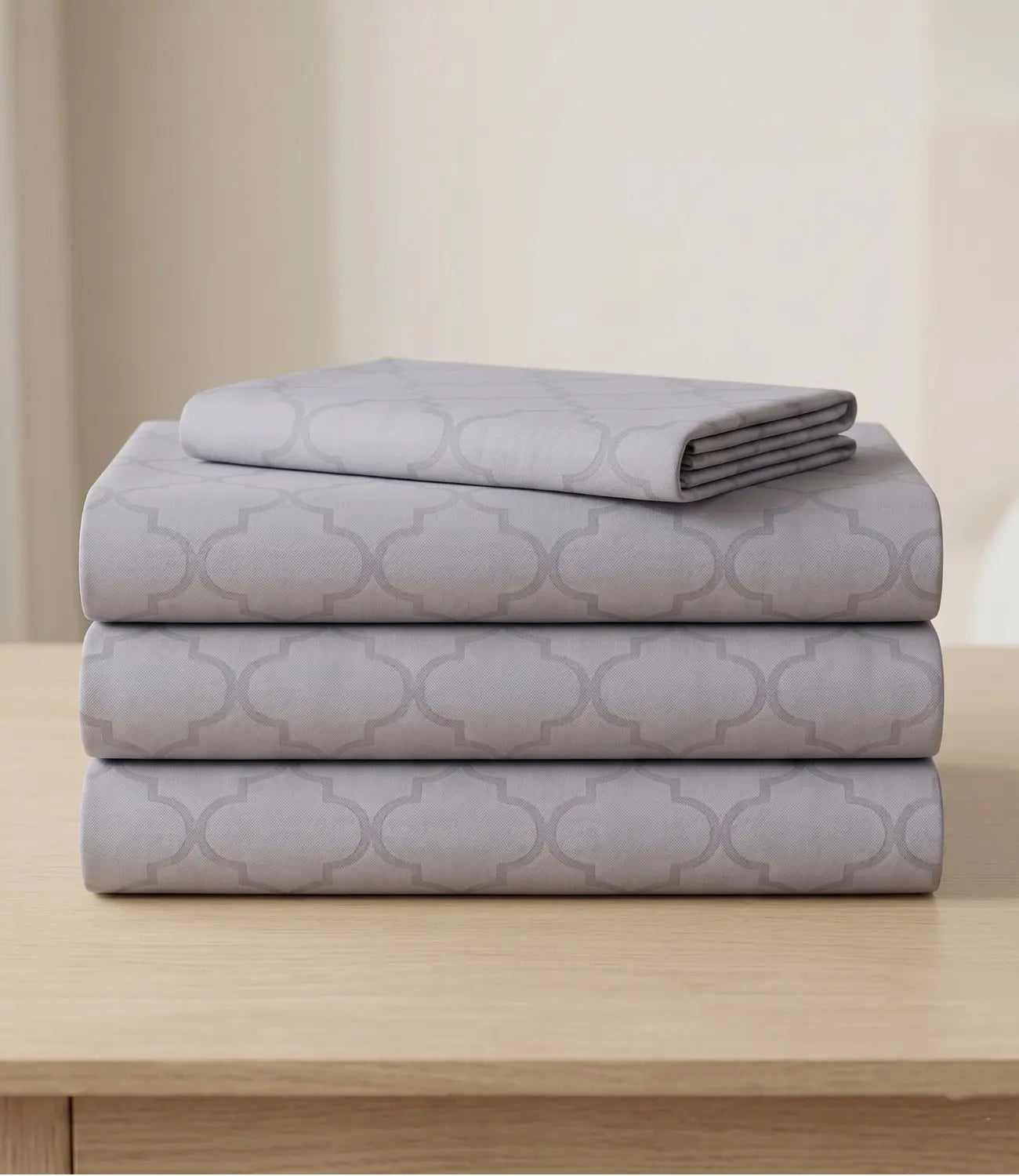 Folded silver grey king size cotton bedsheet set with matching geometric print, ideal for modern and minimalist bedrooms.