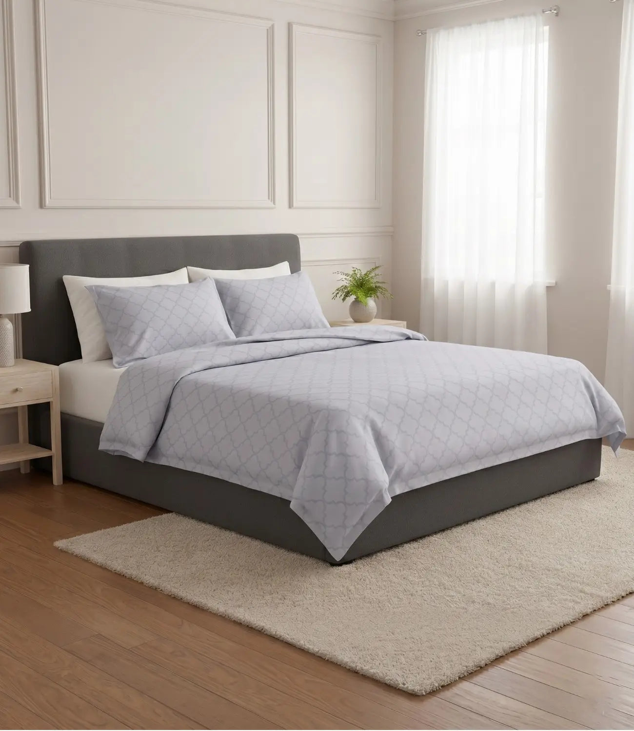 Premium slate blue cotton bedsheet featuring a minimalist geometric print styled on a king size bed in a contemporary bedroom.