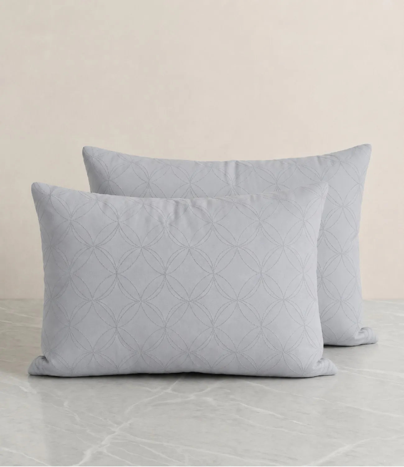 Close-up of a premium 100% pure cotton slate blue geometric bedsheet showcasing its smooth drape, breathable weave, fine stitching, and elegant circular pattern.