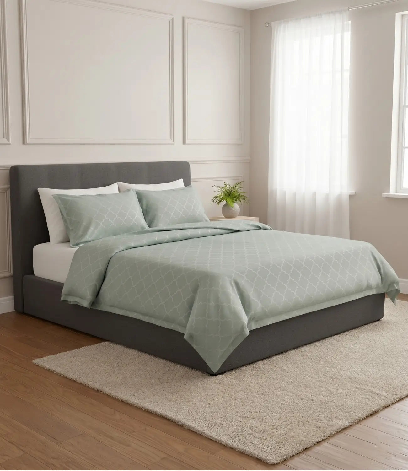 Premium light sage green geometric cotton bedsheet with matching pillowcases styled on a luxury upholstered bed in a contemporary bedroom.