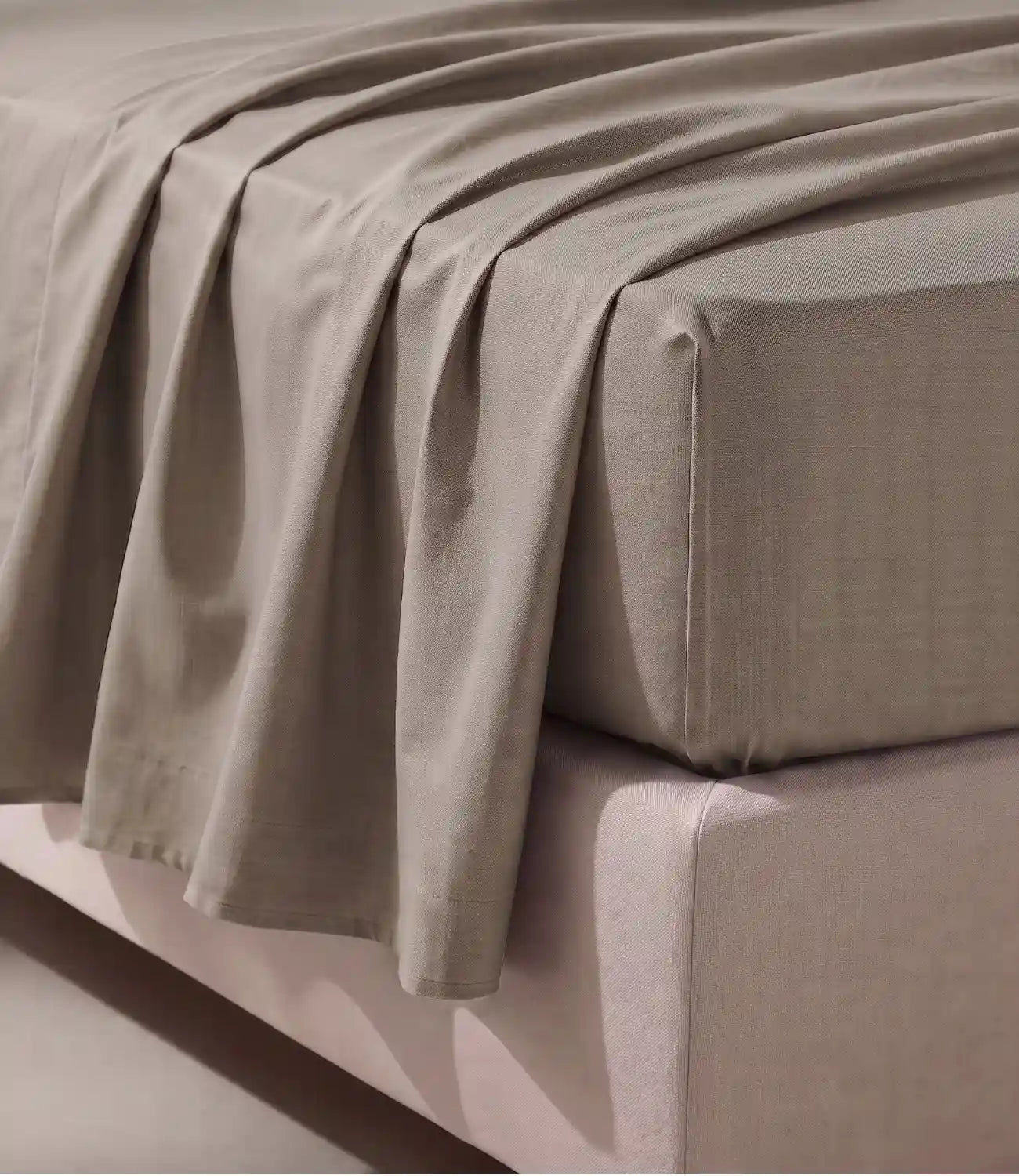 Close-up of a premium 100% pure cotton mocha solid bedsheet highlighting its soft breathable weave, smooth drape, fine stitching, and luxurious everyday comfort.