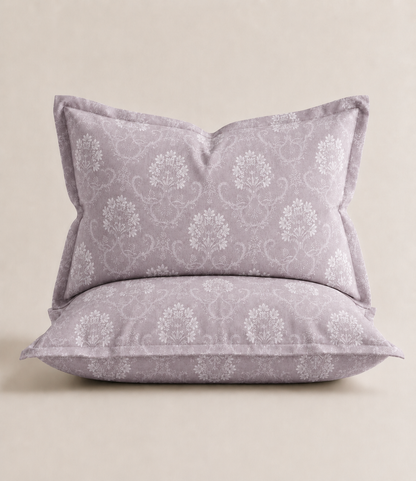 Matching king size pillow cover in misty lilac cotton featuring an intricate white floral vine damask pattern. Soft, breathable fabric complements the coordinating bedsheet for an elegant bedroom look.