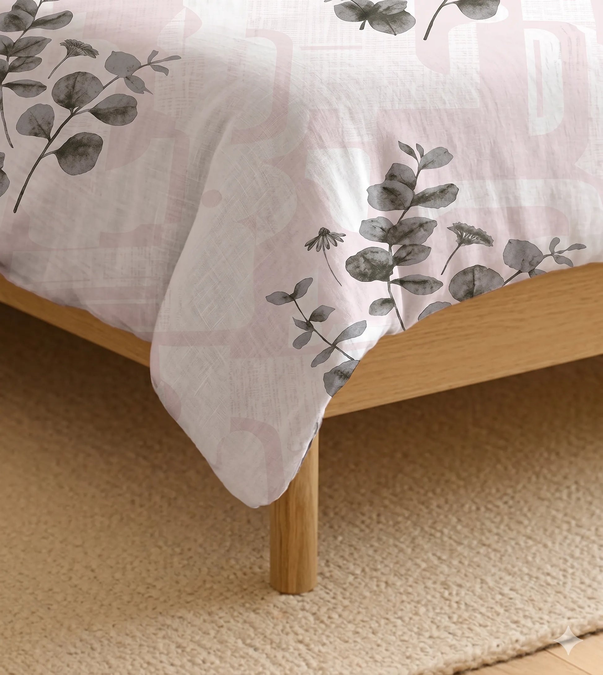Close-up of blush eucalyptus botanical print cotton bedsheet highlighting soft fabric texture and elegant floral design