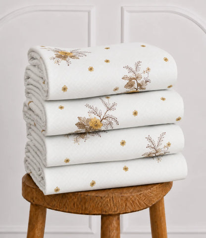 Folded Arizona Golden Blossom queen size cotton bedsheet showcasing soft white fabric with golden floral pattern for everyday comfort.