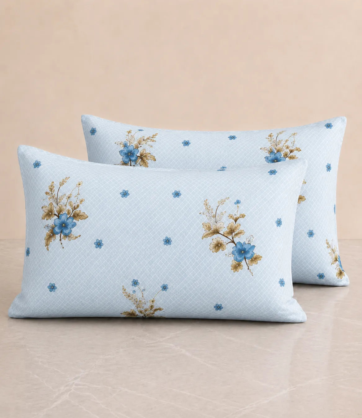 Set of two matching cotton pillow covers in light blue with blue floral bouquet prints and subtle dotted motifs, designed to complement the bedsheet.
