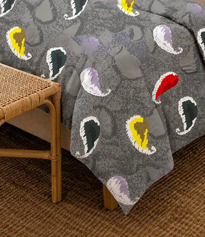 Close-up of a premium 100% cotton charcoal grey bedsheet featuring colorful paisley motifs with soft texture, breathable fabric, and elegant drape.