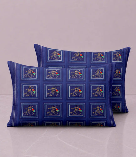 Set of premium cotton pillow covers in deep indigo blue with heritage-inspired geometric square motifs and elegant floral artwork.
