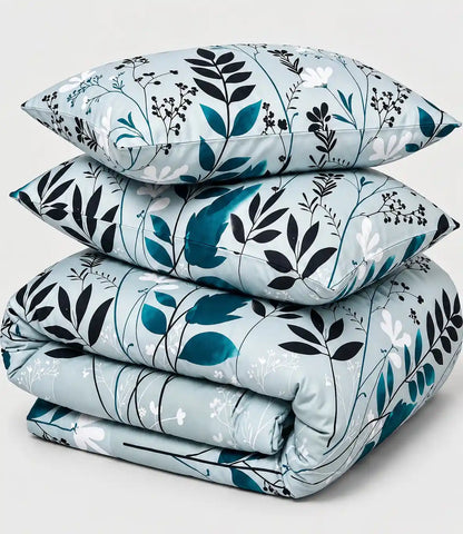 Folded premium 100% cotton bedsheet with matching pillow covers showcasing a modern sage green botanical leaf and floral print.