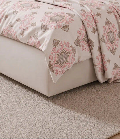 Detailed close-up of a blush pink king size cotton bedsheet featuring elegant royal floral motifs, soft drape, premium cotton fabric, and fine stitching.
