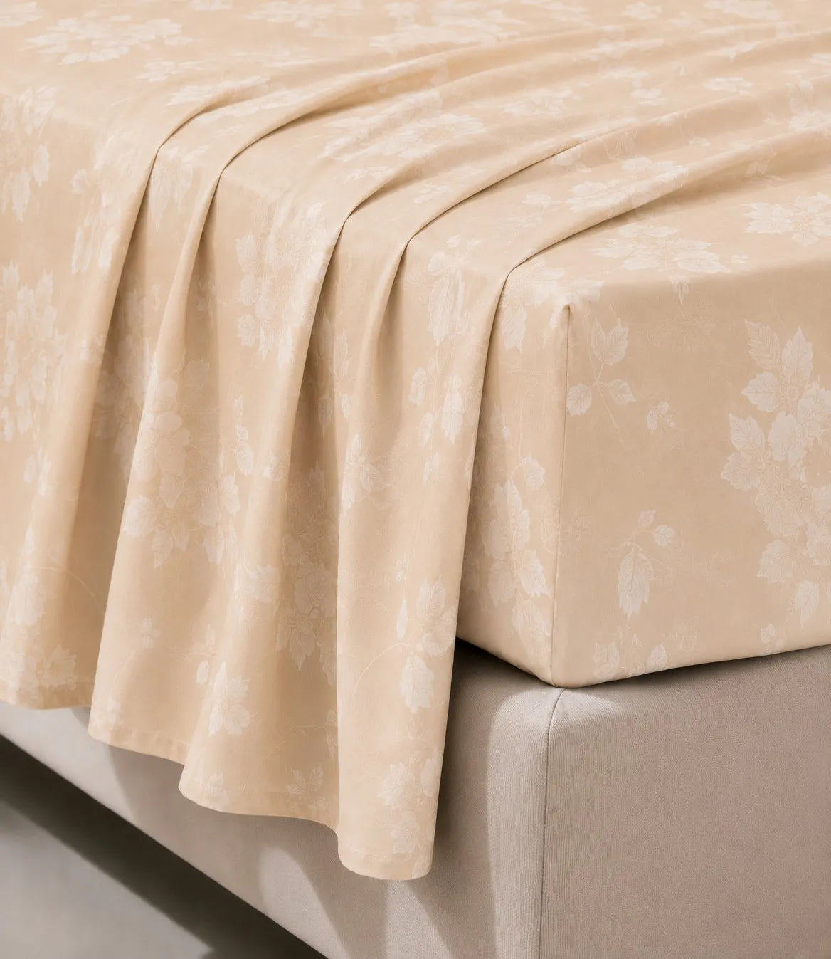 Close-up of king size beige floral cotton bedsheet showing soft drape, detailed blossom pattern, wrinkle-resistant fabric, and premium stitching.