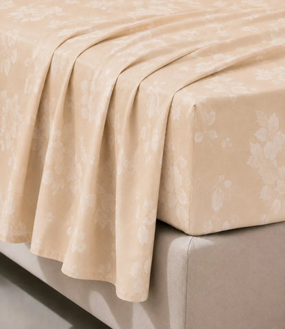 Close-up of king size beige floral cotton bedsheet showing soft drape, detailed blossom pattern, wrinkle-resistant fabric, and premium stitching.