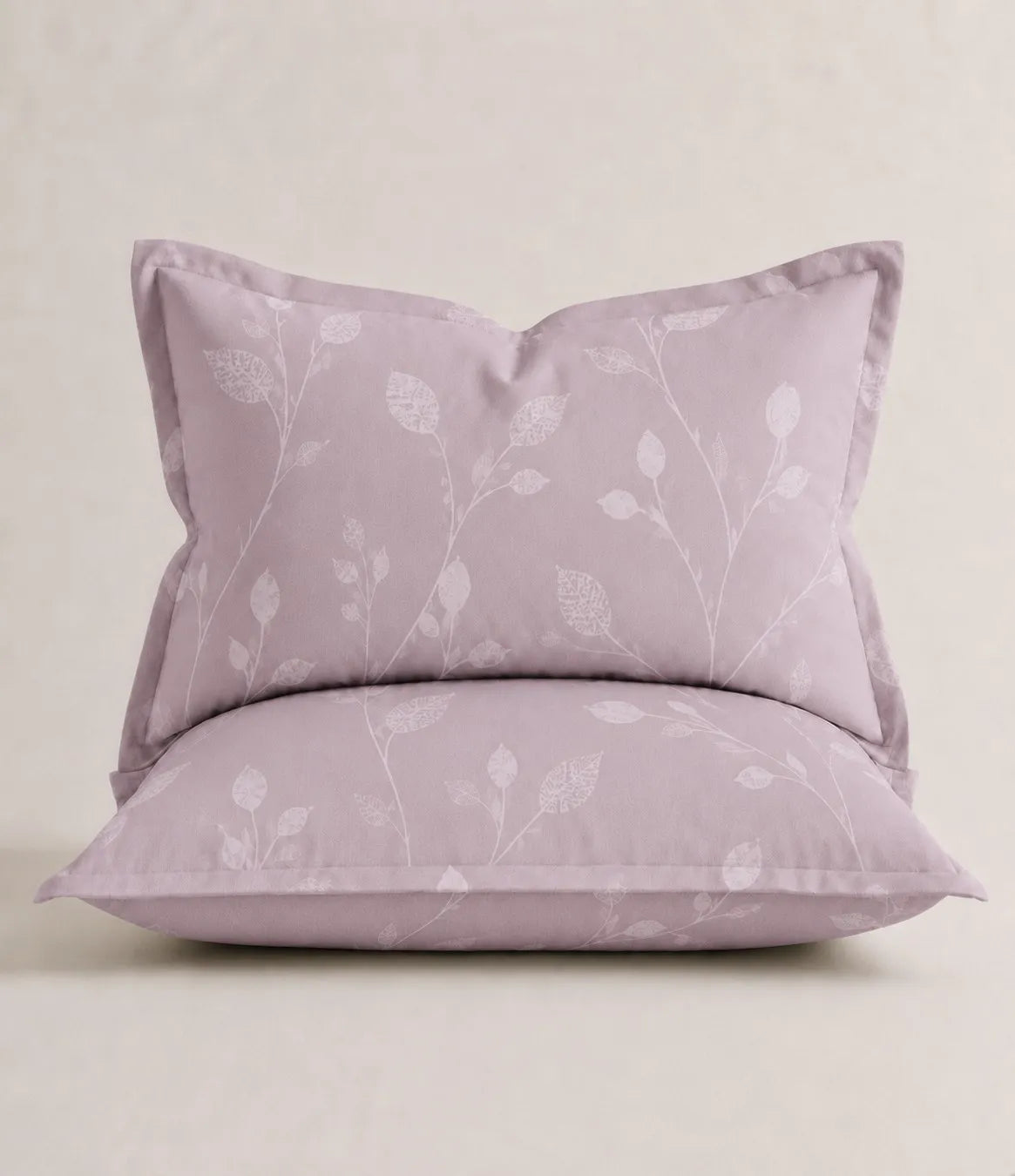 Matching blush lavender pillow cover featuring an elegant white botanical vine design, displayed on a cushioned pillow to showcase the soft cotton fabric, neat stitching, and refined floral pattern.