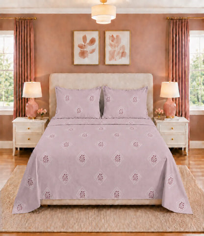 Front view of blush mauve king size cotton bedsheet featuring elegant floral diamond motifs with coordinated pillow covers in a contemporary bedroom.