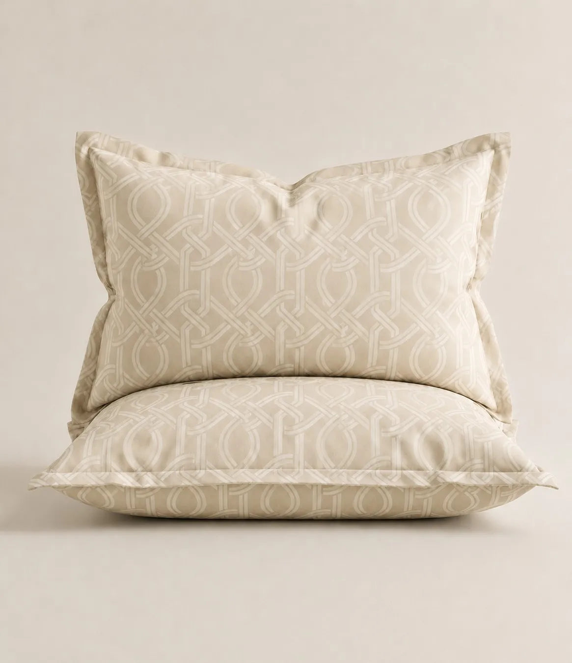 Matching 100% pure cotton ivory pillow covers featuring an elegant interwoven geometric pattern, crafted with breathable fabric, soft texture, and premium quality for a refined bedroom style.