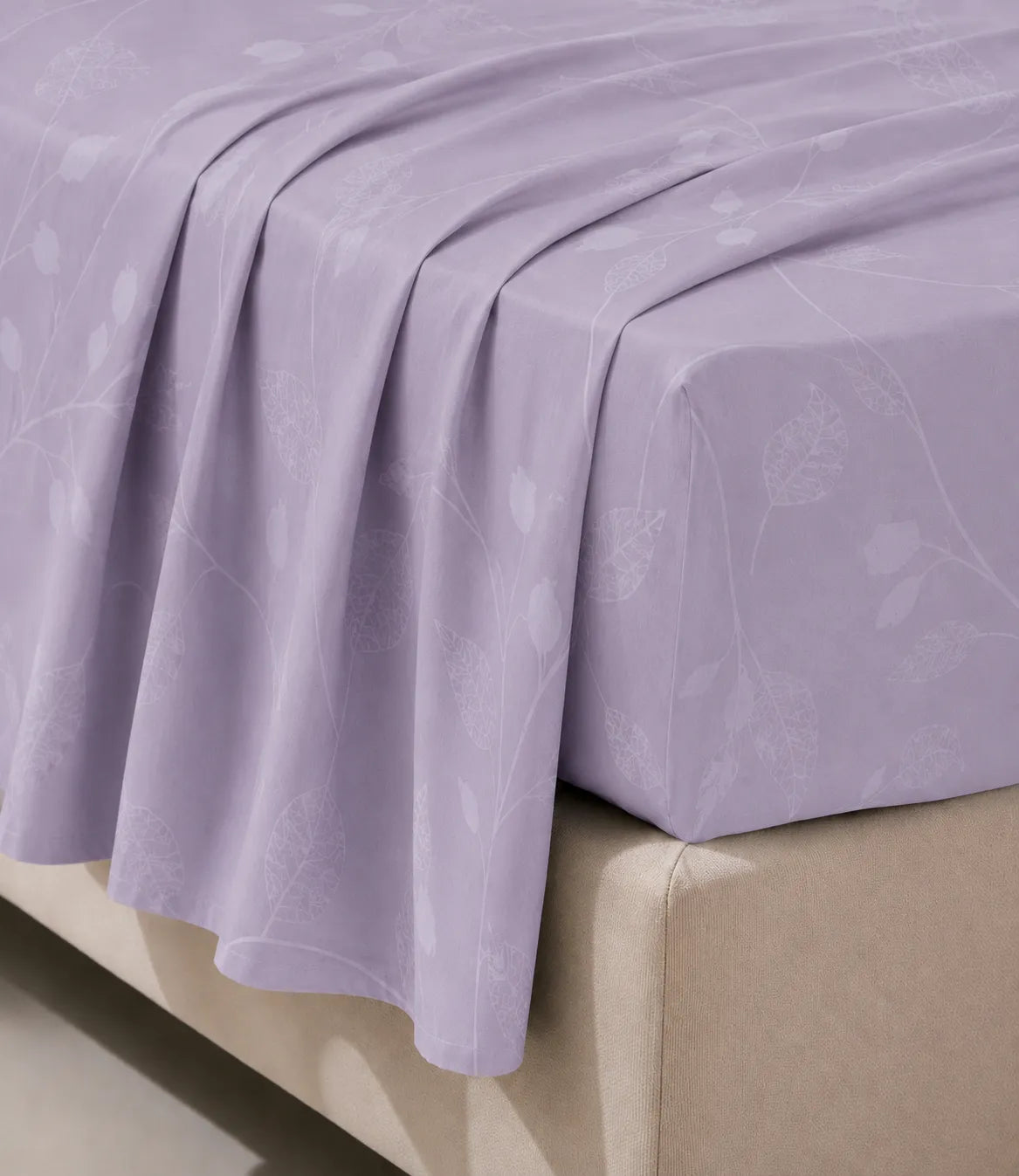 Close-up of the lavender botanical vine cotton bedsheet draped over the mattress, highlighting the smooth fabric, elegant print, and fine stitching.