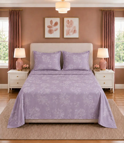King size lavender floral bed sheet with two matching pillowcases featuring a soft botanical print in a contemporary bedroom.