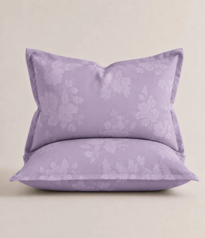 Lavender floral pillowcase with elegant white botanical print from a king size cotton bed sheet set.