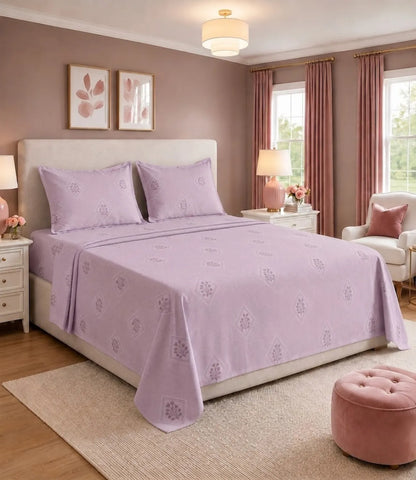 King size lavender cotton bedsheet with elegant floral diamond print, paired with matching pillow covers in a modern bedroom. Soft pastel purple bedding offers a stylish, breathable, and comfortable look for everyday use.