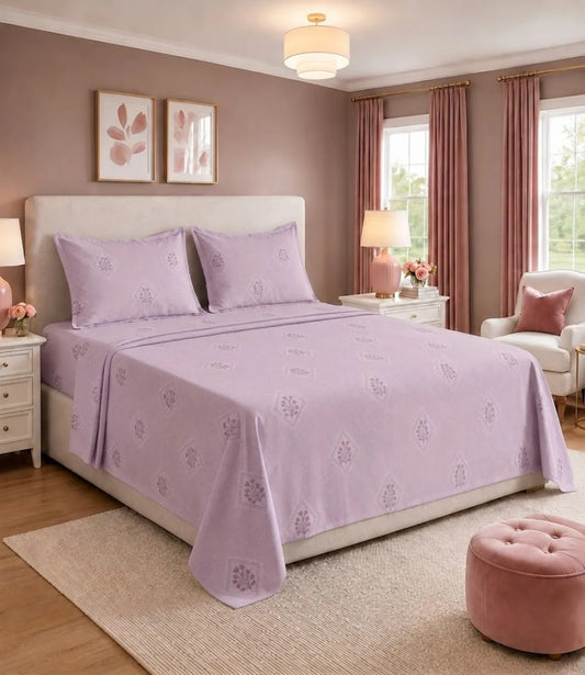 King size lavender cotton bedsheet with elegant floral diamond print, paired with matching pillow covers in a modern bedroom. Soft pastel purple bedding offers a stylish, breathable, and comfortable look for everyday use.