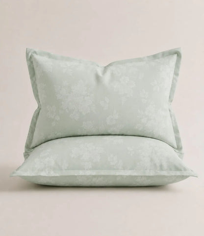 Matching king size mint green floral pillowcase with delicate white botanical pattern and soft, breathable fabric.