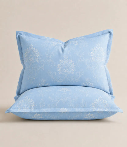 Matching king size sky blue cotton pillow covers with delicate white floral vine print, designed for a coordinated and elegant bedding look.