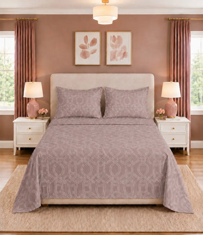 Front view of blush mauve geometric king size cotton bedsheet set with matching pillow covers in an elegant modern bedroom.