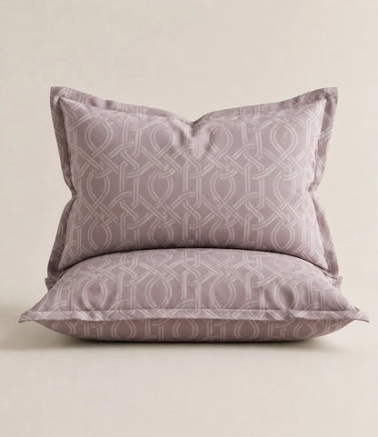 Blush mauve cotton pillow covers with interwoven geometric pattern, matching king size bedsheet set.