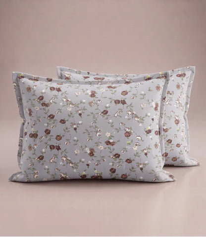 Matching 100% pure cotton pillow covers with elegant brown, blush pink, white, and sage green floral prints on a soft light grey base, offering a refined and premium bedroom aesthetic.