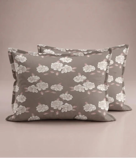 Matching 100% pure cotton pillow covers with elegant white floral prints and soft blush leaves on a warm taupe background, creating a refined and luxurious bedroom aesthetic.