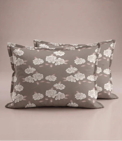 Matching 100% pure cotton pillow covers with elegant white floral prints and soft blush leaves on a warm taupe background, creating a refined and luxurious bedroom aesthetic.