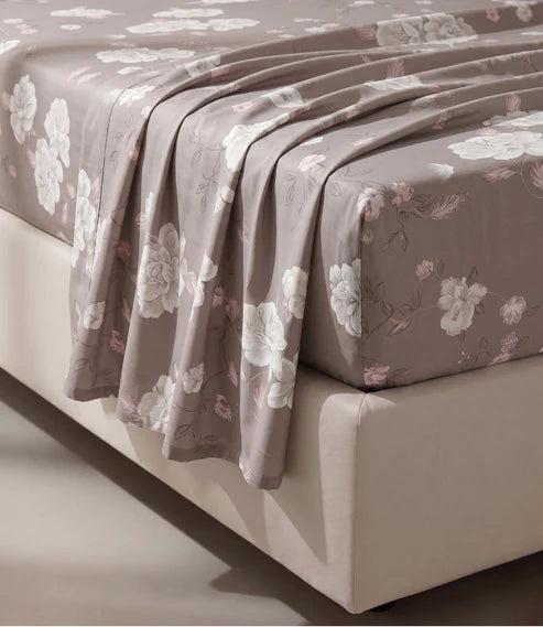 Close-up of a premium 100% pure cotton floral bedsheet displaying its smooth breathable cotton fabric, elegant white floral design with soft blush leaves, luxurious weave, and naturally soft drape.