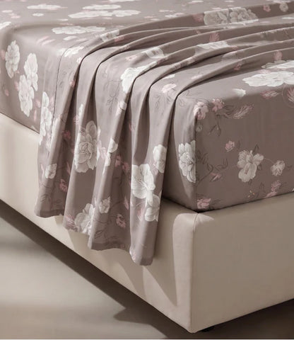 Close-up of a premium 100% pure cotton floral bedsheet displaying its smooth breathable cotton fabric, elegant white floral design with soft blush leaves, luxurious weave, and naturally soft drape.