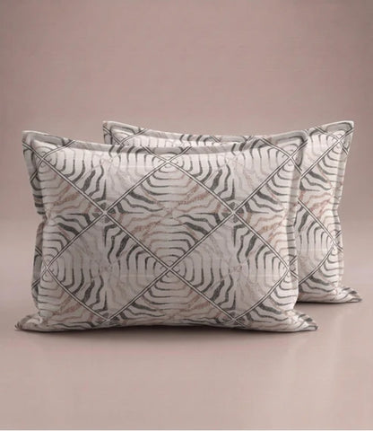 Matching 100% pure cotton pillow covers featuring an elegant ivory, taupe, and grey abstract geometric stripe pattern for a modern bedroom.