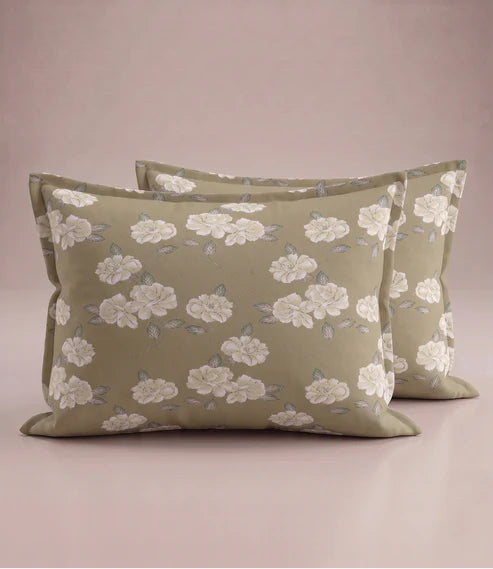 Matching 100% pure cotton pillow covers with elegant white floral prints and sage green leaves on a warm olive beige background, offering a timeless, premium, and luxurious bedroom aesthetic.