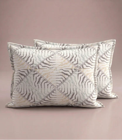 Matching 100% pure cotton pillow covers featuring an elegant beige, taupe, and grey abstract geometric print for a contemporary bedroom.
