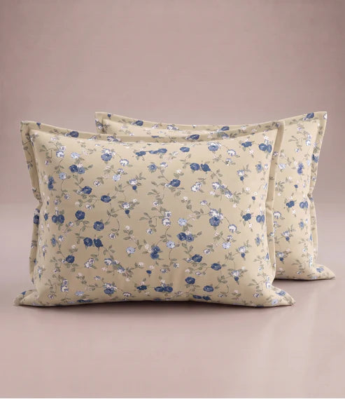 Matching 100% pure cotton pillow covers with delicate blue, white, and sage green floral prints on a warm beige base, offering a timeless, elegant, and premium bedroom look.
