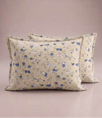 Matching 100% pure cotton pillow covers with delicate blue, white, and sage green floral prints on a warm beige base, offering a timeless, elegant, and premium bedroom look.