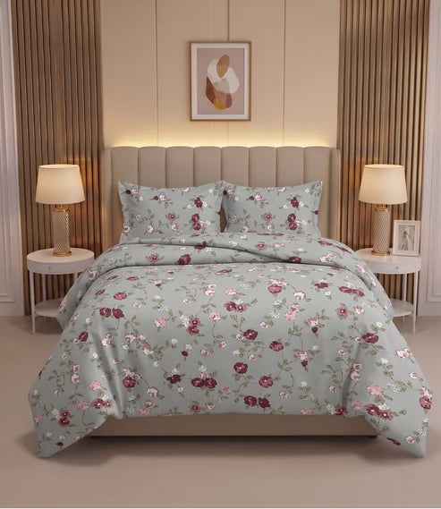 Premium queen size 100% pure cotton bedsheet with a delicate floral print in soft sage green, blush pink, burgundy, ivory, and olive tones, beautifully styled in a modern luxury bedroom with matching pillow covers.