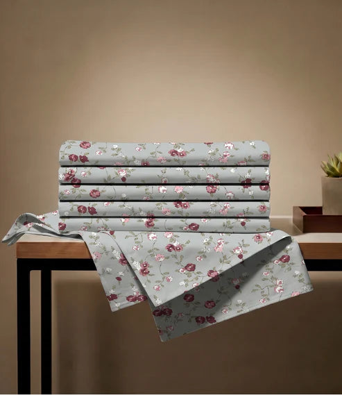 Folded queen size 100% pure cotton floral bedsheet with a soft botanical print in sage green, blush pink, burgundy, ivory, and olive tones, showcasing premium breathable fabric.