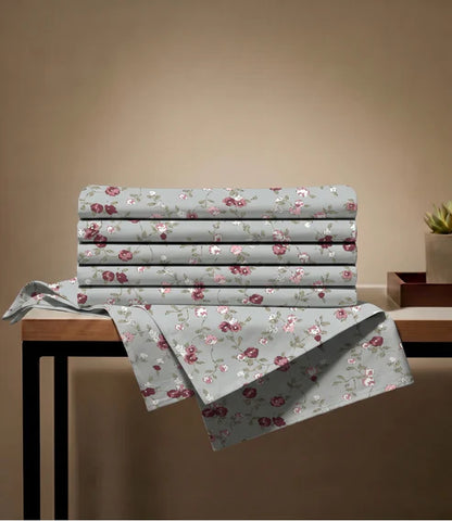 Folded queen size 100% pure cotton floral bedsheet with a soft botanical print in sage green, blush pink, burgundy, ivory, and olive tones, showcasing premium breathable fabric.