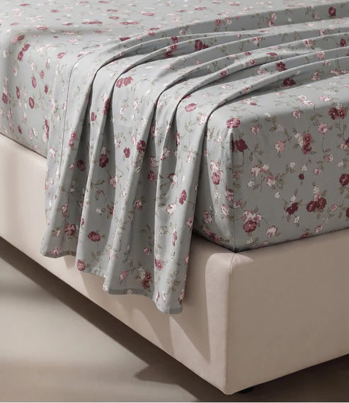 Close-up of a premium 100% pure cotton floral bedsheet highlighting its soft breathable fabric, smooth cotton weave, and elegant botanical print in muted pastel shades.
