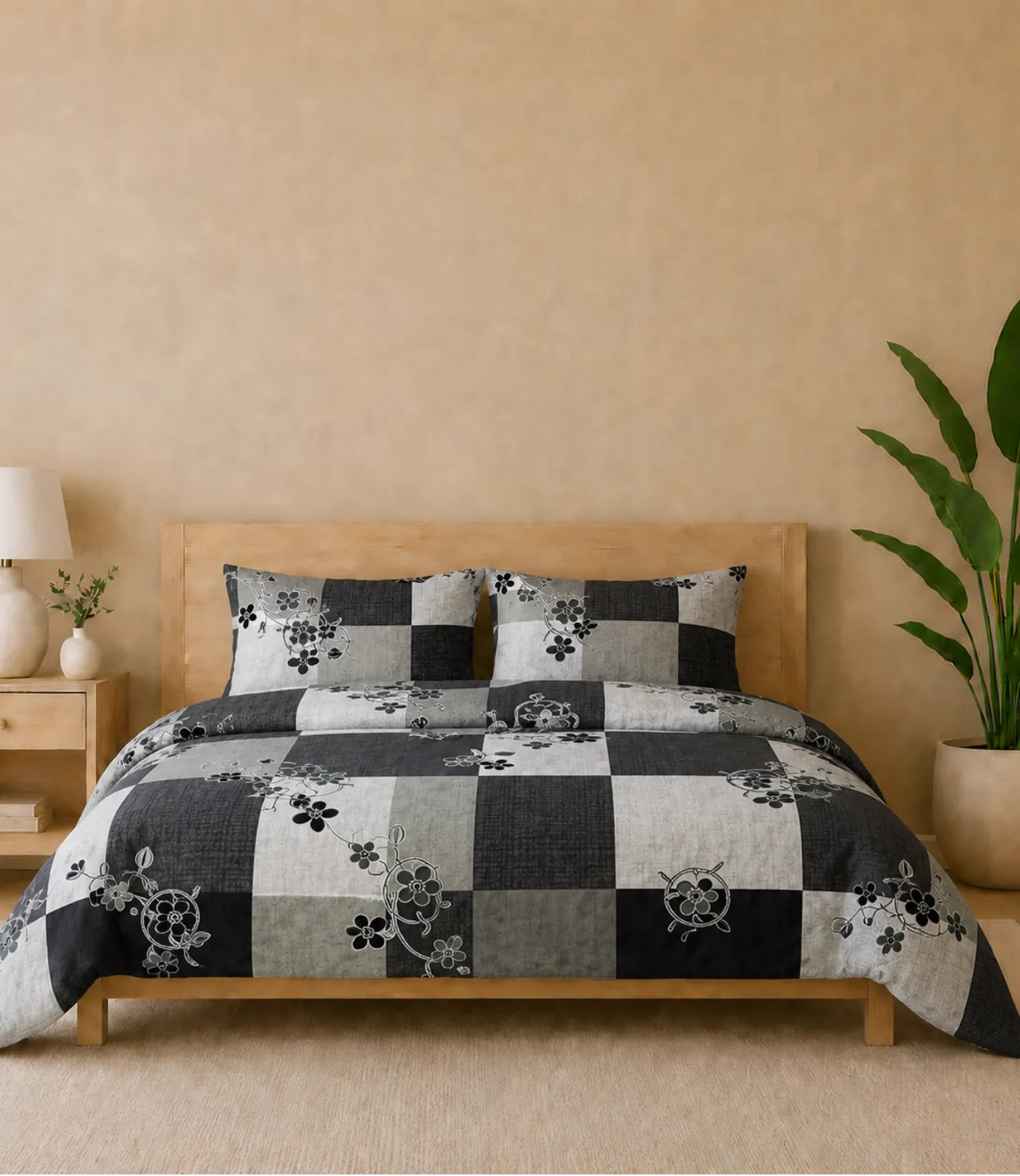 Premium queen size 100% pure cotton bedsheet featuring a modern charcoal grey and light grey checkered pattern with elegant black floral vine accents, styled in a contemporary wooden bedroom with matching pillow covers for a sophisticated and stylish look.