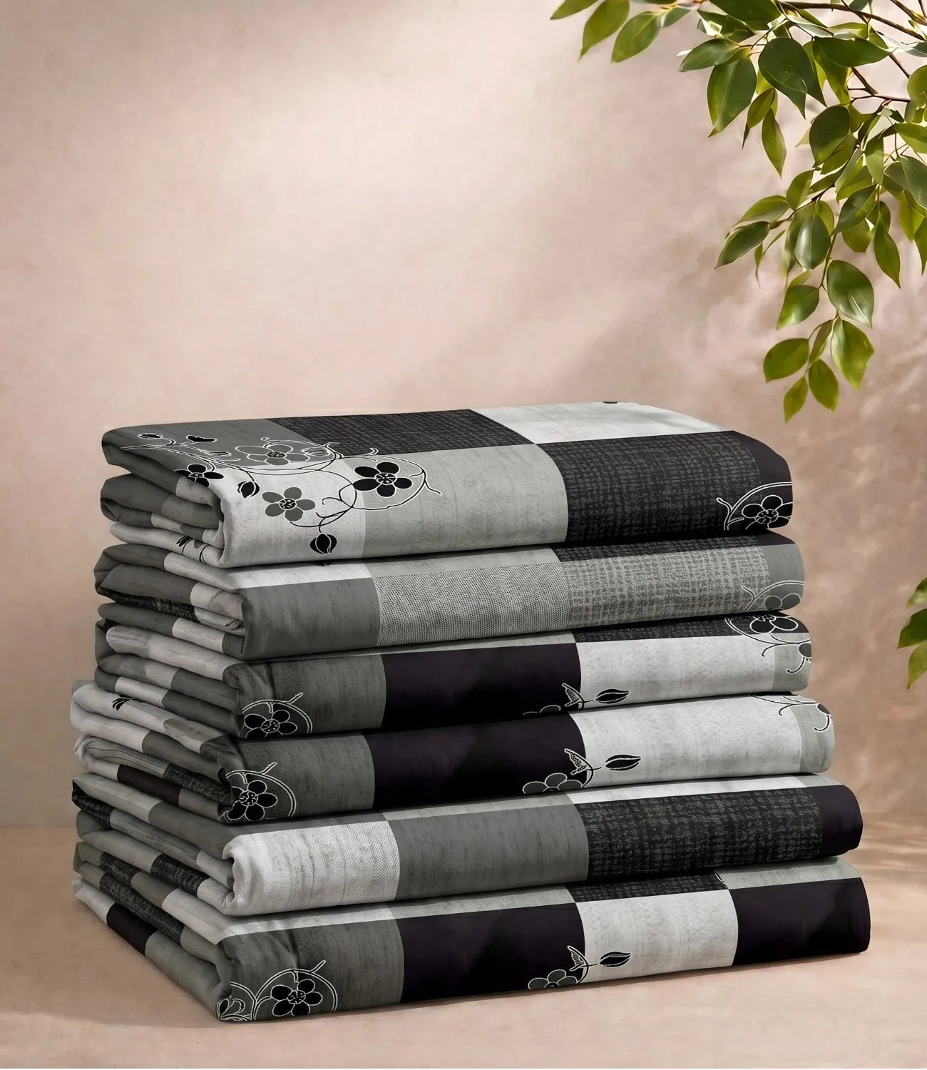 Folded queen size 100% pure cotton charcoal grey checkered bedsheet showcasing a contemporary floral check pattern, soft breathable cotton fabric, premium craftsmanship, and everyday comfort.