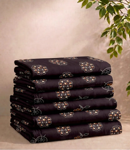 Folded queen size cotton bedsheet in midnight plum showcasing an all-over ethnic floral motif print, neatly stacked for fabric and pattern display.