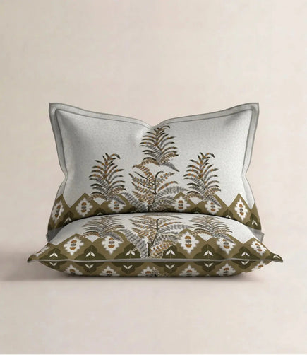 Matching 100% cotton pillow cover featuring an olive green botanical print with decorative border on a soft white background.