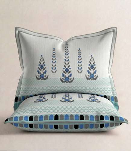 Matching 100% cotton pillow cover featuring a royal blue traditional floral motif with an elegant geometric border on a soft white background.